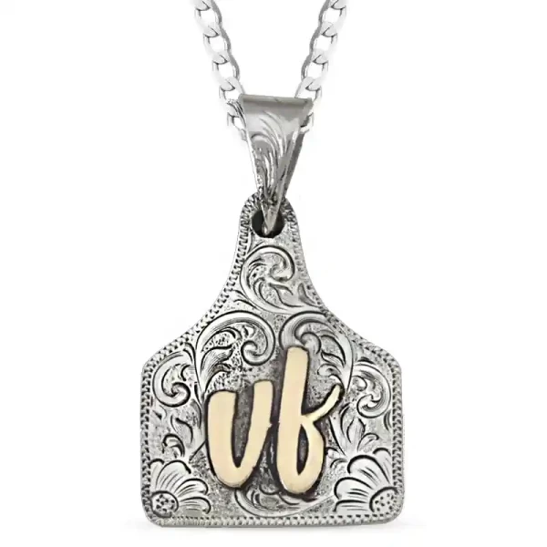 Embrace understated elegance with the Conway Cow Tag Necklace. Crafted on a hand-engraved German Silver base and detailed with Jeweler's Bronze script lettering, this necklace combines simplicity with sophistication. Personalize it with your initials to m